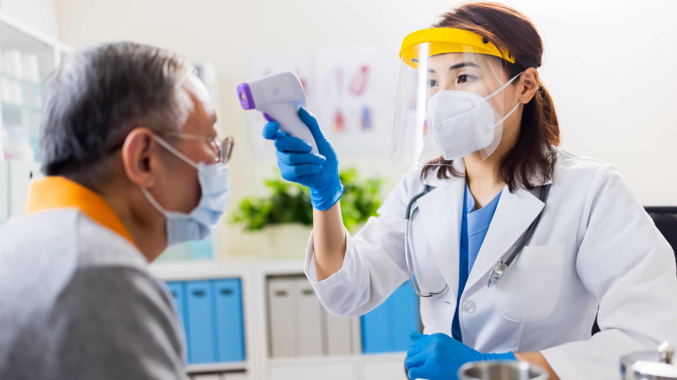 patient getting temperature taken by doctor