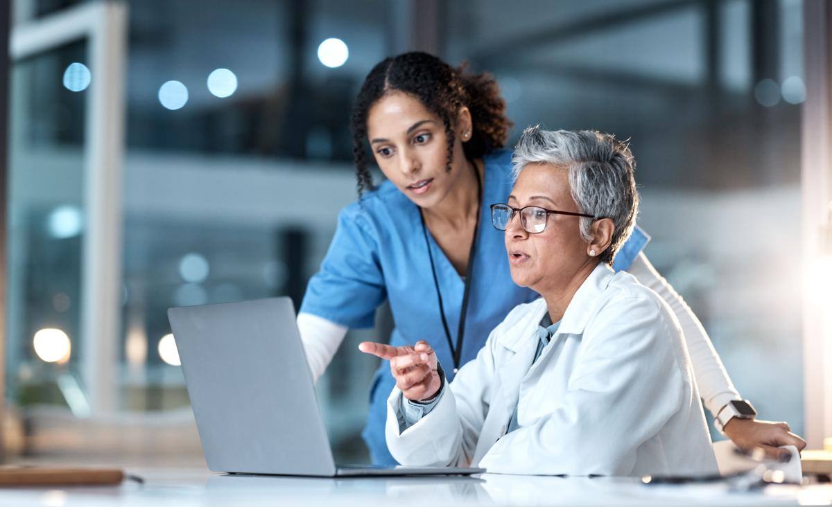 Two doctors looking at a laptop